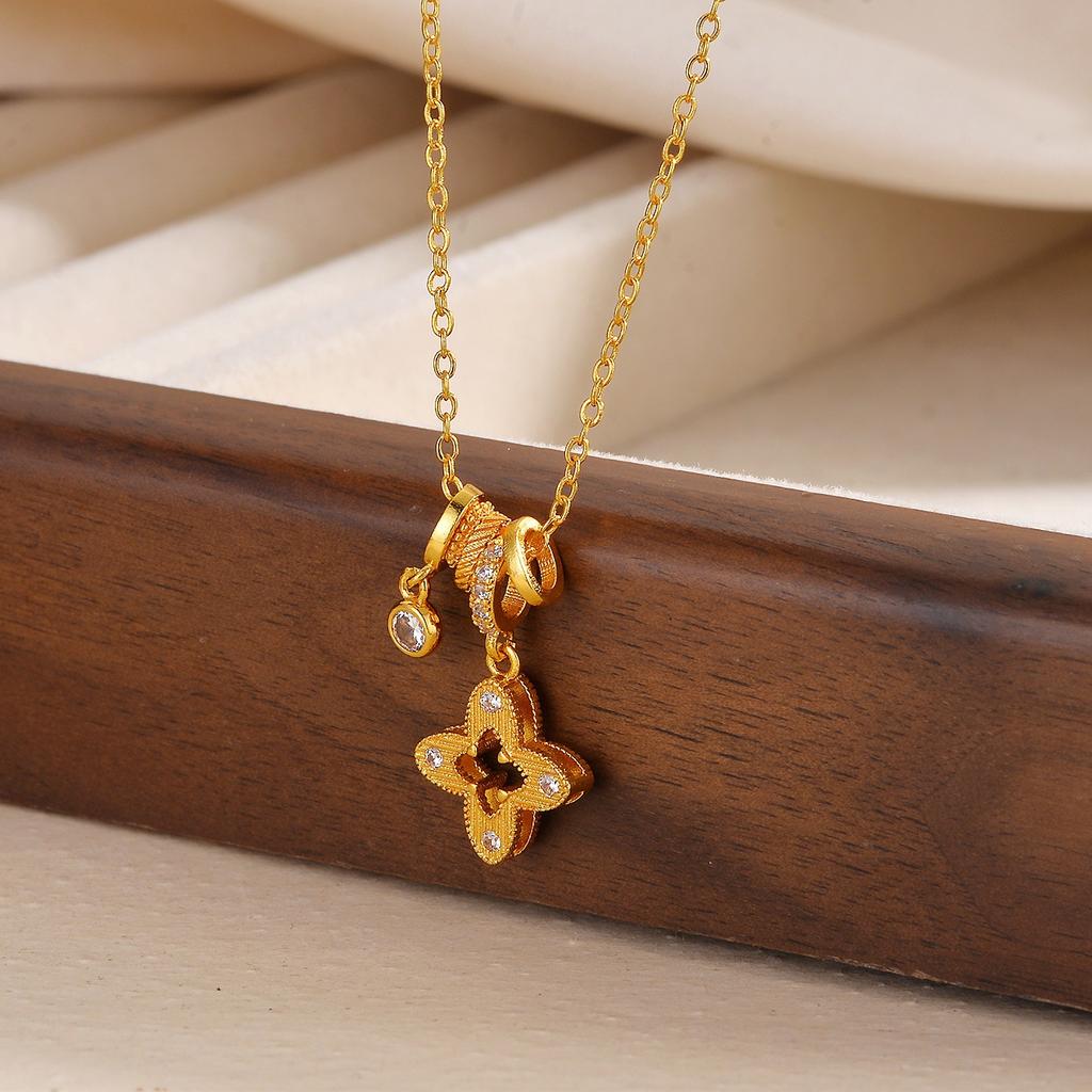 Gold hollow four-leaf flower necklace, a delicate and luxurious piece with a unique design, perfect for pairing with sweaters