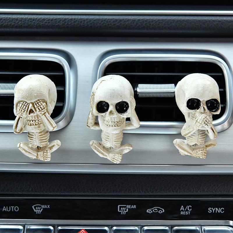 Creative car skull ornaments with the design of "see no evil, hear no evil, speak no evil", which are car interior decorations.