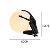 Modern Nordic Table Lamp Sculpture: Creative Doll Holding Luminous Ball for Bedroom and Living Room Decor
