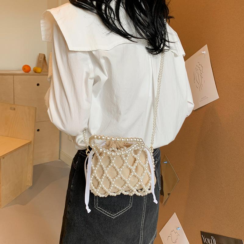 Bag exquisite hand-woven hollow personality women's handbag new imitation pearl woven shoulder messenger bag
