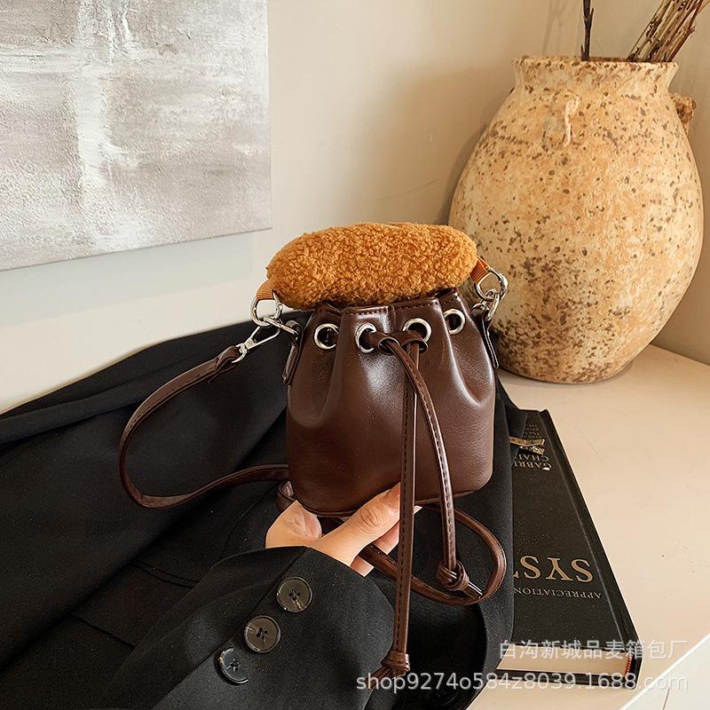 

2025 autumn and winter new small and lightweight drawstring bucket bag children s mini hand carry diagonal span accessories bag women s bag explosion