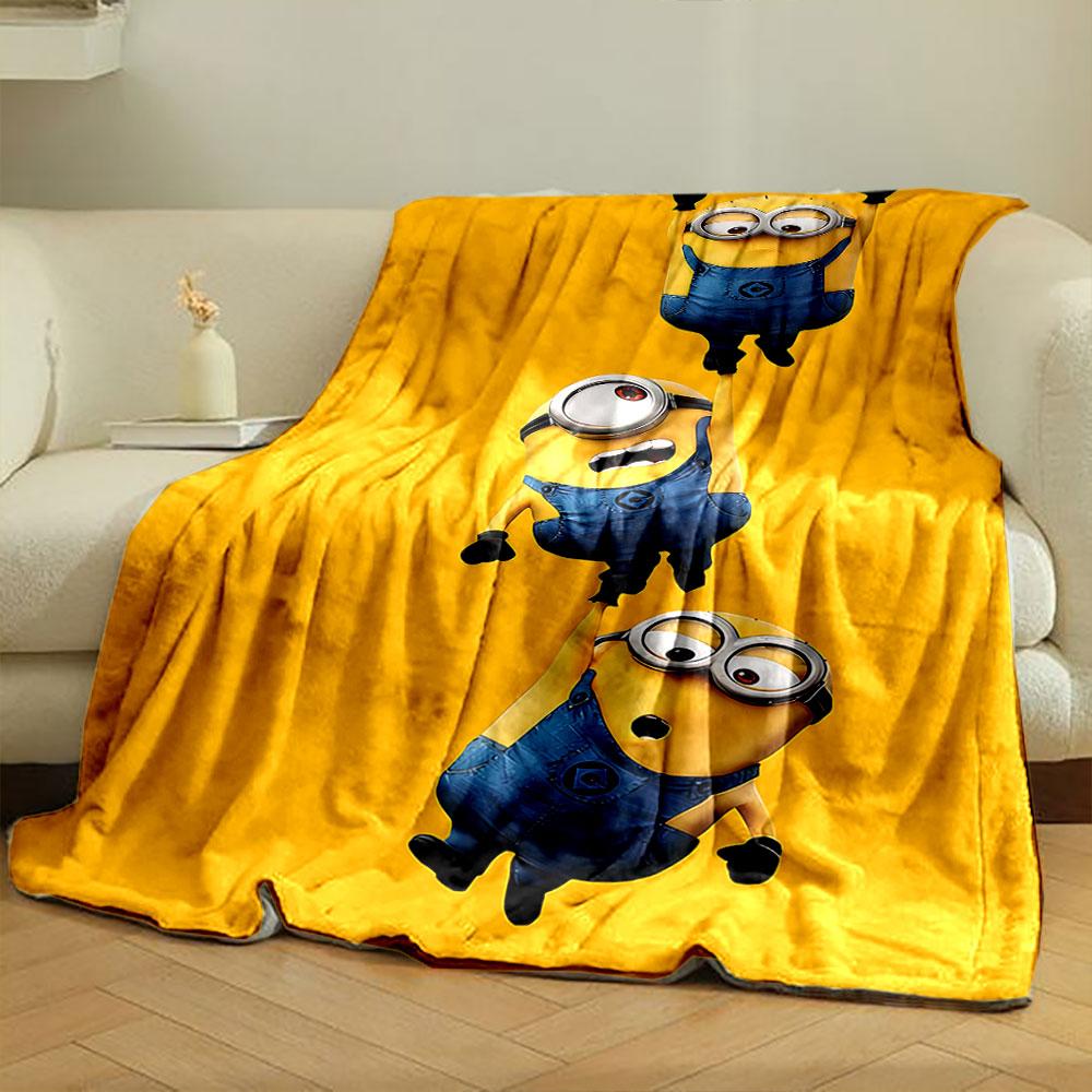 Three Minions in blue overalls hanging from each other on a yellow background. for all seasons blanket lunch break throw gift