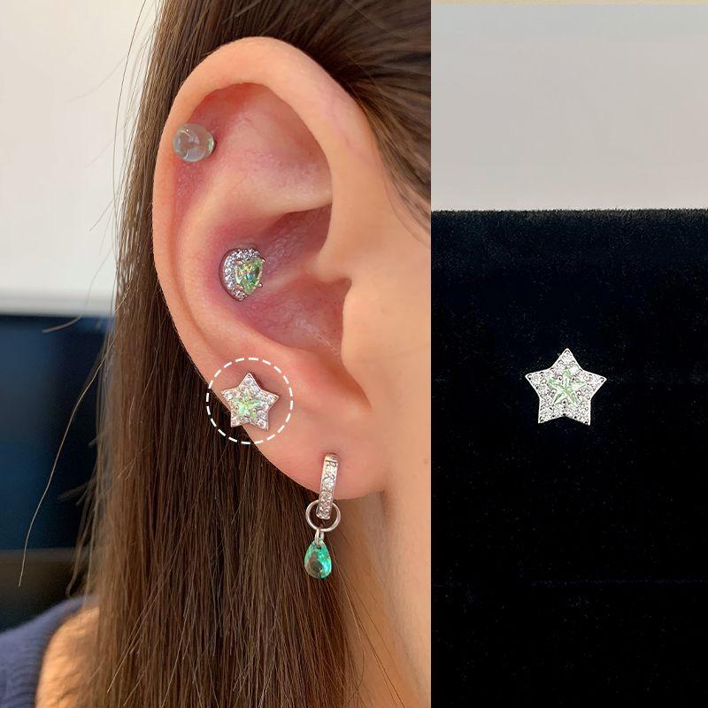 

Xinghe Bright Medical Titanium Steel Female Flats Ear Bone Stud White Green Star 1