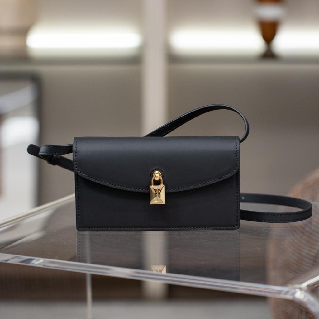 A Small Square Canvas Women's Bag with a Unique Lock and a Light Luxury Style Made of Cowhide