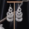 Bohemian Ethnic Miao Silver Tassel Earrings with Butterfly, Peacock, and Flower Design for Women – Long Dangle Jewelry for Travel Photos.