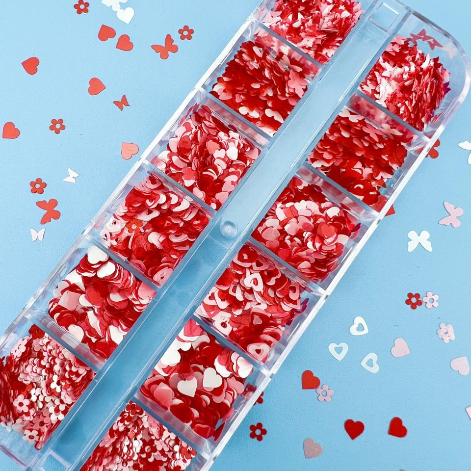 12-Grid Valentine's Day Nail Art Box: Pink Butterfly, Flower, Heart, and Mixed Sequins in Pink, White, and Red.