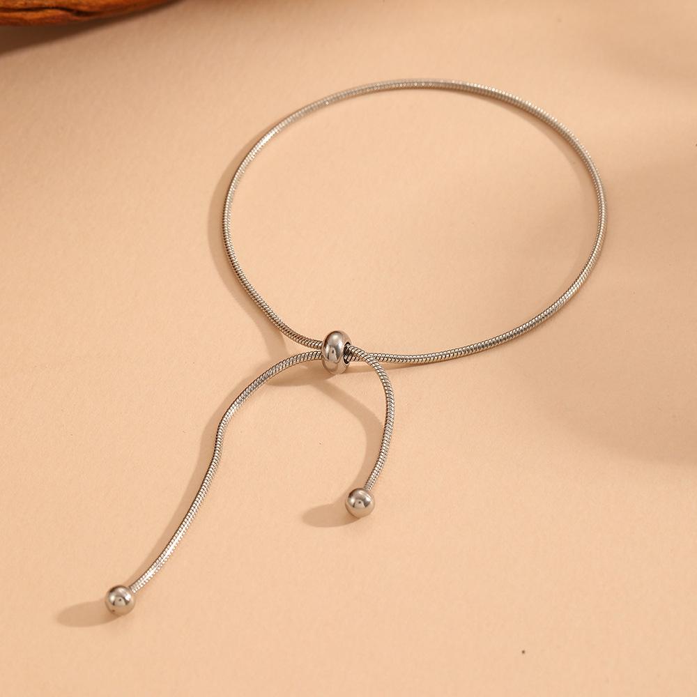 Luxury European Retro Tassel Clavicle Chain: 18K Gold Titanium Snake Chain with Cross Pull-Through for Women