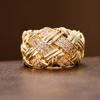 Retro woven and set with artificial gemstones ring made of copper. Women's jewelry ring suitable for formal events.