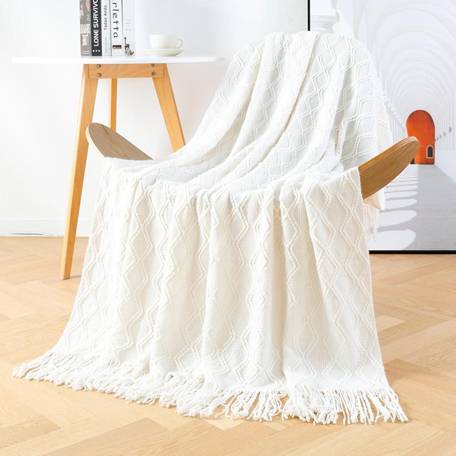Orange knitted throw blanket for model homes, suitable for use as a sofa or bed throw, for furniture stores and home showrooms as a soft decoration
