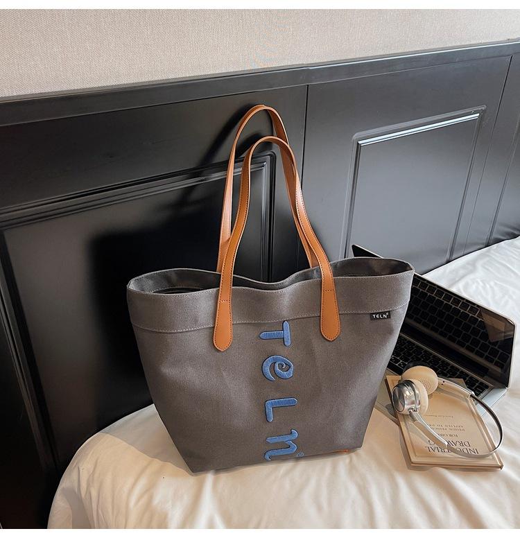 

Large capacity canvas bag 2025 summer new shoulder bag casual tote bag letter embroidery trend commuter women s bag