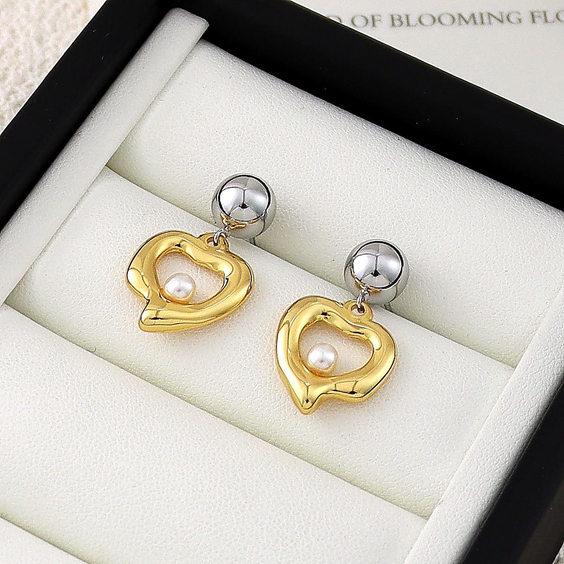 Elegant Hollow Heart Pearl Stud Earrings - Chic Design with Versatile and Sophisticated Appeal for Women.
