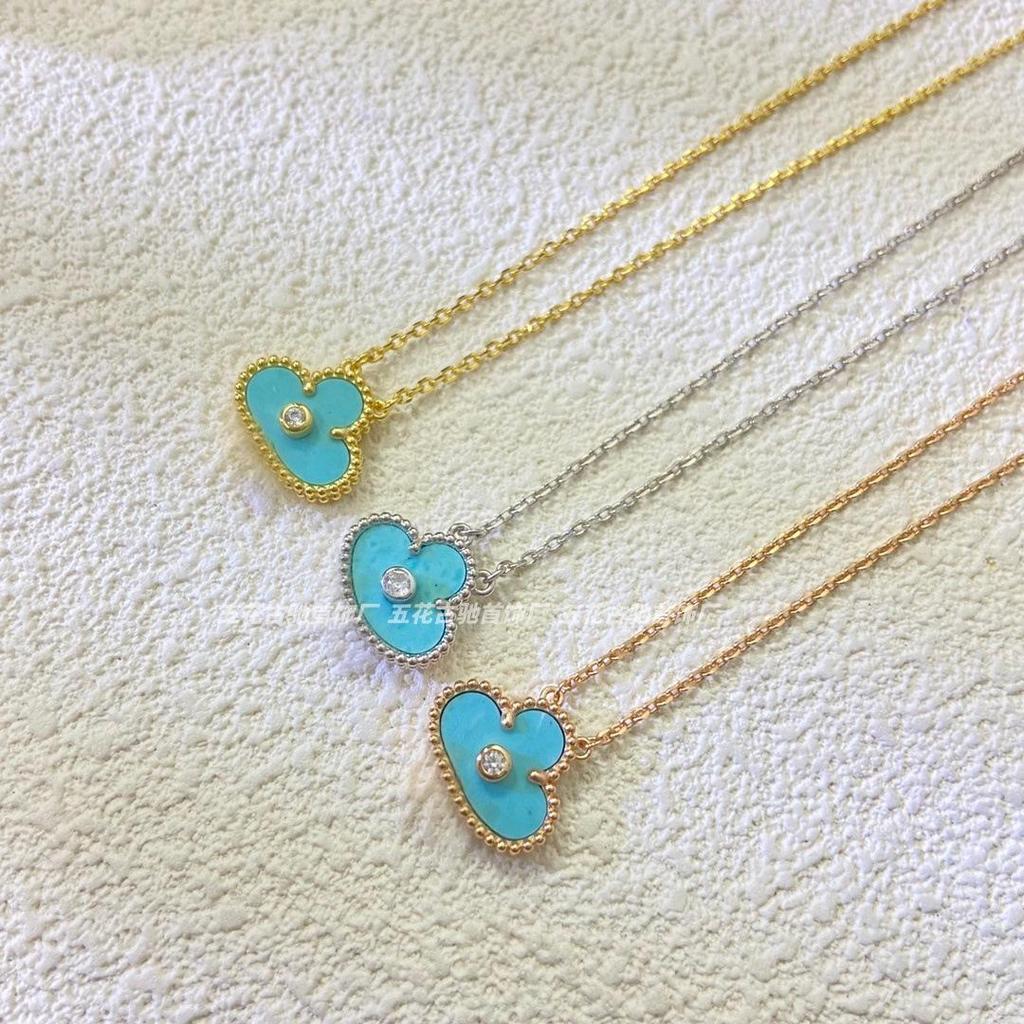 Náhrdelník Van Cleef se čtyřlístkem: Zlatý přívěsek pro ženy s pětilistým designem, bílou perletí, červeným achátem a diamantem.