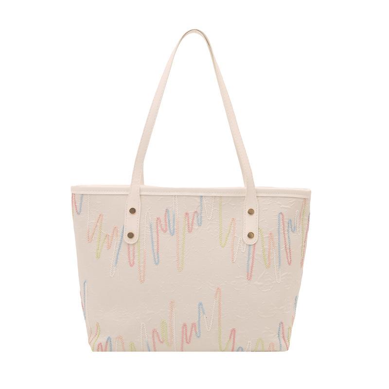 This year, the popular tote bag women's large-capacity 2025 new simple and cute pendant texture commuting shoulder bag
