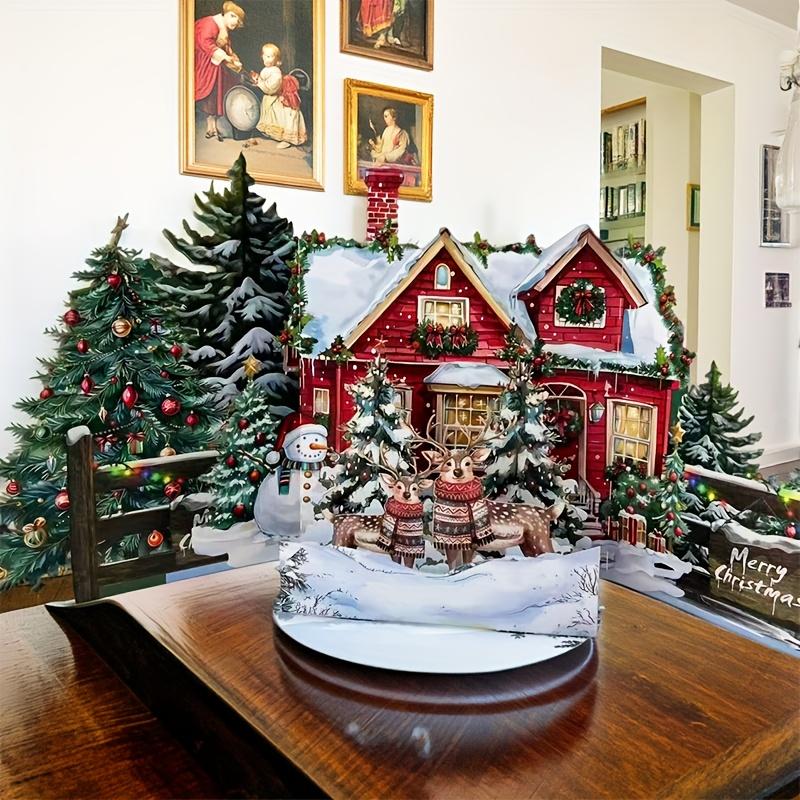 1 Pop-Up Christmas Card: A three-dimensional snowy winter cottage and gingerbread house display—a festive pop-up greeting card