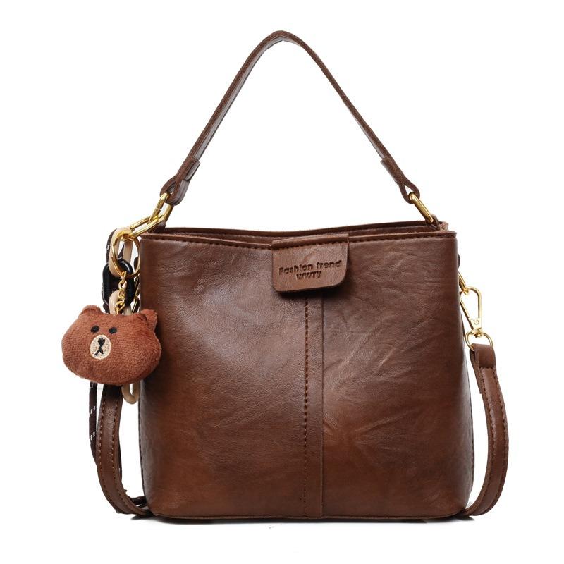 Neue trendige Mode mit Anhänger Schulter Damenhandtasche Retro Schulter Große Kapazität Breitband Umhänge Eimerhandtasche
