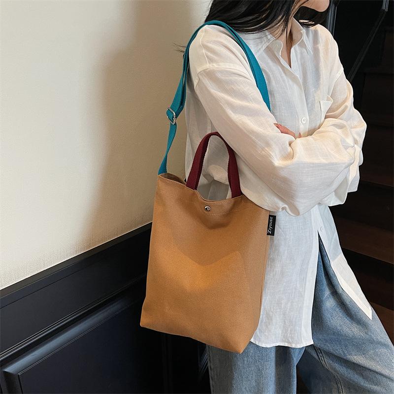 Portable shoulder tote cloth bag women's new simple commuting design sense niche large-capacity leisure bucket bag