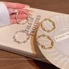 Cold wind metal texture twisted circle earrings women's year new fashion niche design simple earrings