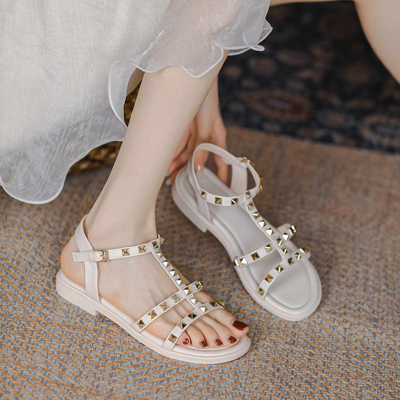 2025 summer new versatile flat-bottomed fairy style with skirt rivets Roman fashion Internet celebrity sandals women