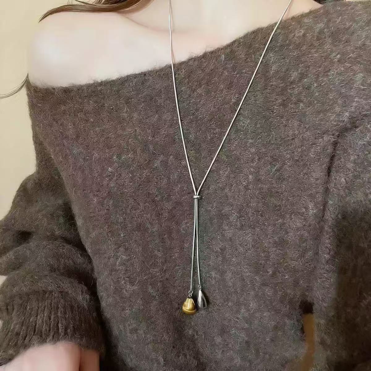 

Tiger s eye stone water drop pulling necklace women s 1111 new popular light luxury niche design long sweater chain accessories