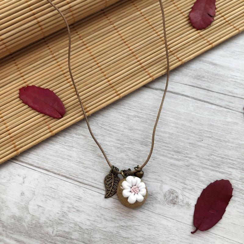 

Handmade retro sweet small fresh ceramic pinched flower necklace female long bell fringed pendant versatile jewelry