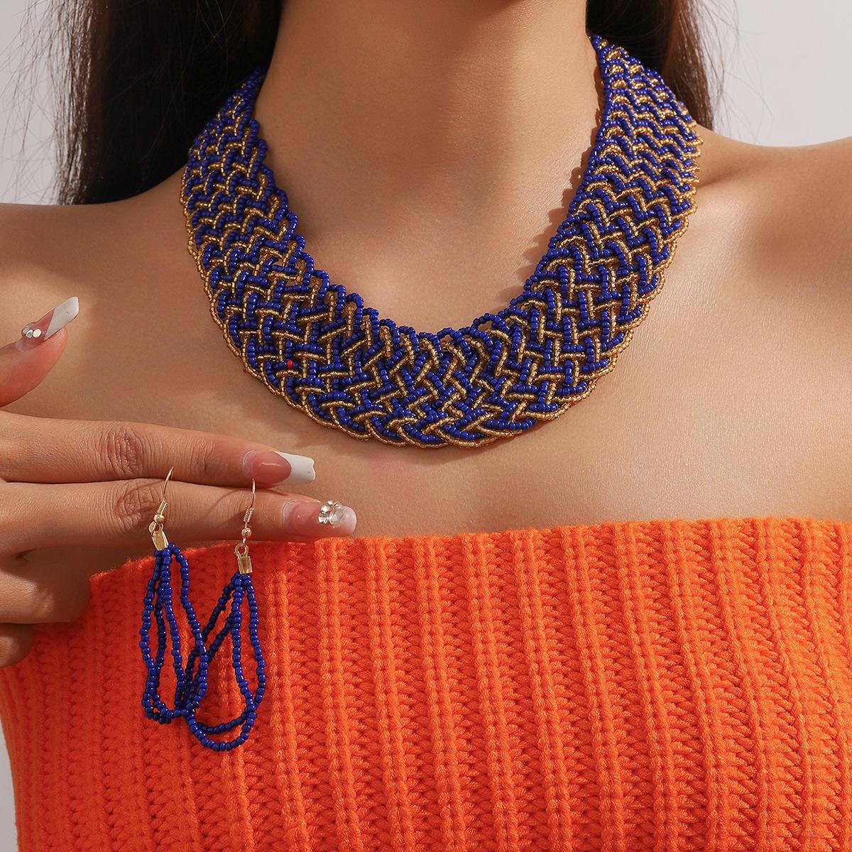 

Комплект из двухцветных бусин-крестиков с подвеской в виде ожерелья и серег фиолетовый