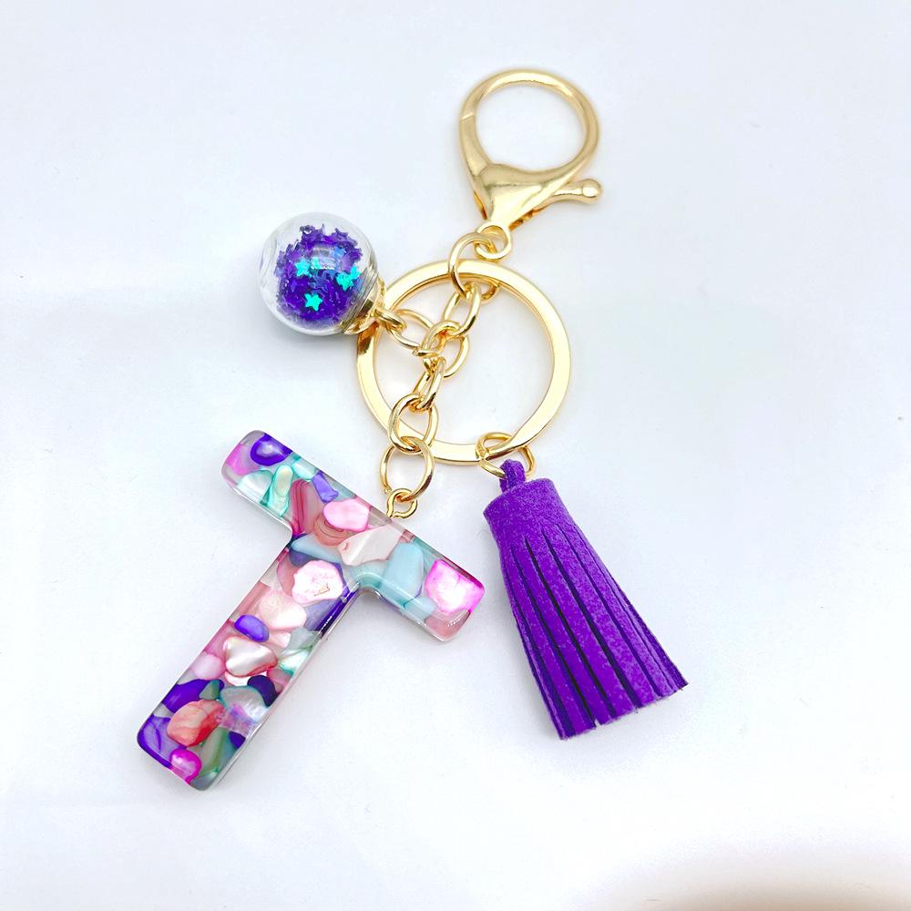 Europäischer und Amerikanischer Bestseller Englischer Initialschlüsselanhänger mit Lila Quasten-Accessoire