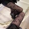 Net Celebrity Style Four-Leaf Clover Fishnet Stockings - Black Silk Pantyhose for Spring and Autumn.