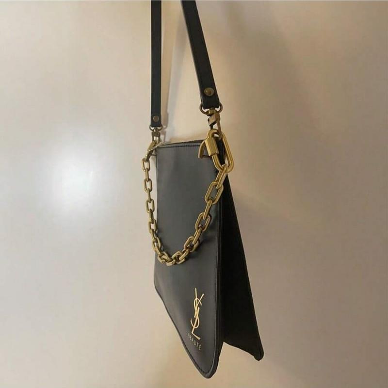 YSL black makeup crossbody bag with chain detailing, portable design, and large capacity, suitable for everyday use and travel.