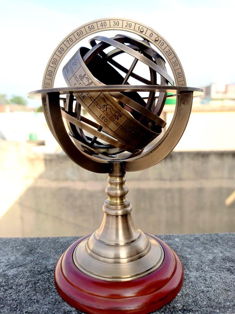 

Antique Brass Armillary Sphere Globe on Wooden Stand – Nautical Desk Decor & Vintage Home Decoration