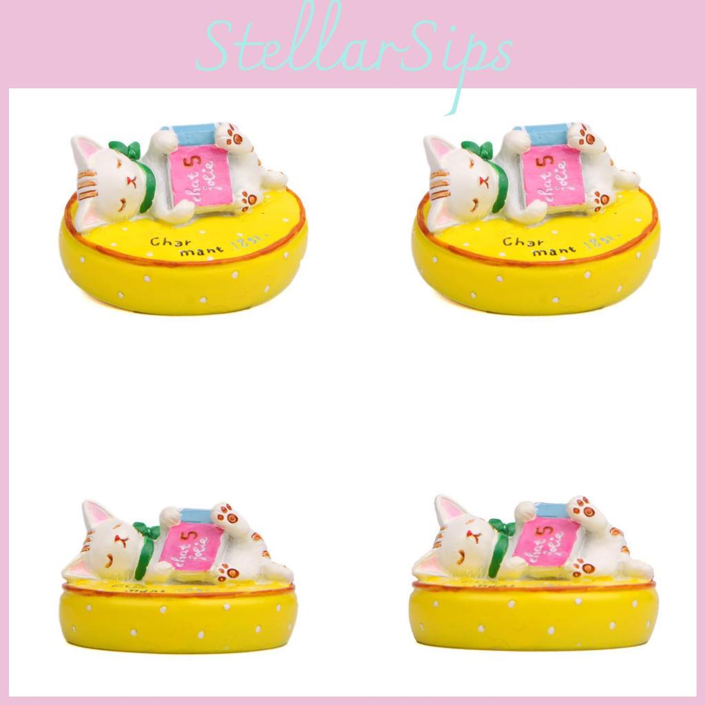 Katze liegt auf einem Kissen und liest ein Buch Harzfigur für Innendekoration und Foto-Requisiten