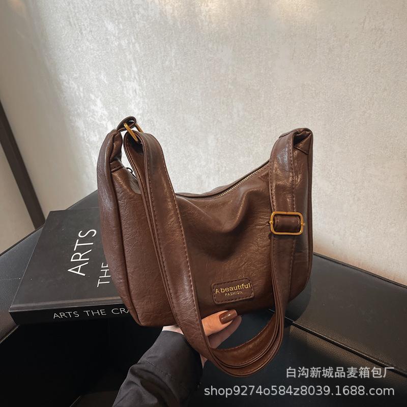

Premium texture soft leather bag women 2025 new trendy Internet celebrity Korean version oblique span bag niche design single shoulder dumpling bag темно-коричневого кольору