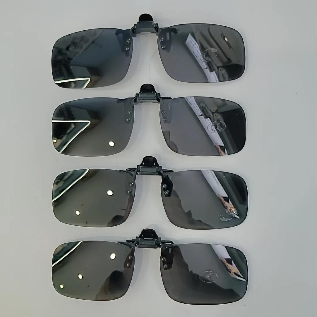 A pair of stylish four-piece flip-on polarized night vision sunglasses with an anti-glare mirror coating, ideal for driving.