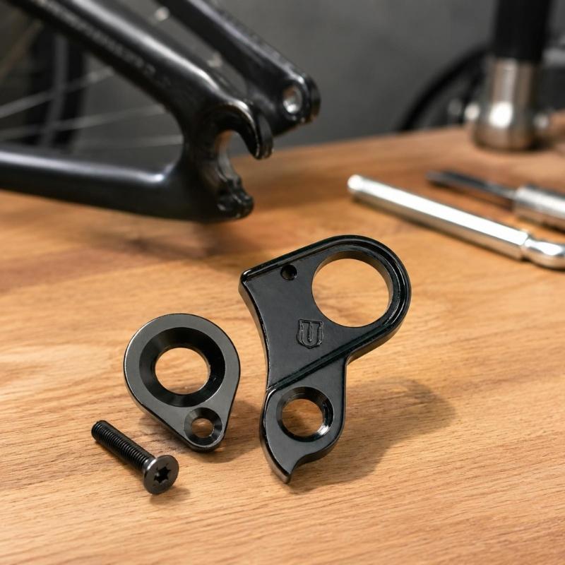 Machined Aluminum Rear Shifting Hanger, Part 10240 H695 with Frame Opening, Bushing Connection, Screw Mounting Point, and Included Screw