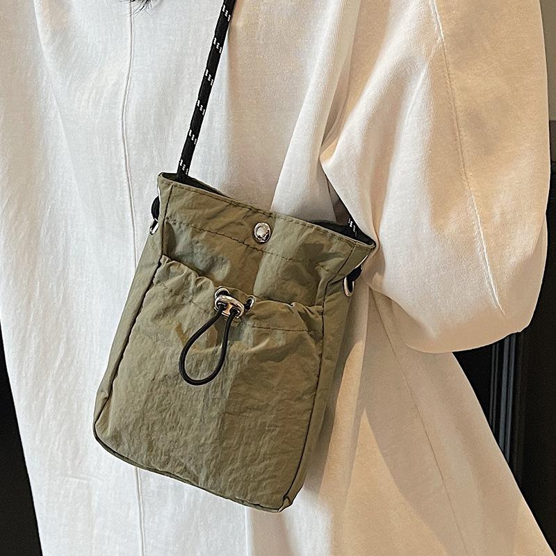 Summer new literary single shoulder messenger bag drawstring small bag niche fashion lightweight mobile phone nylon bag women