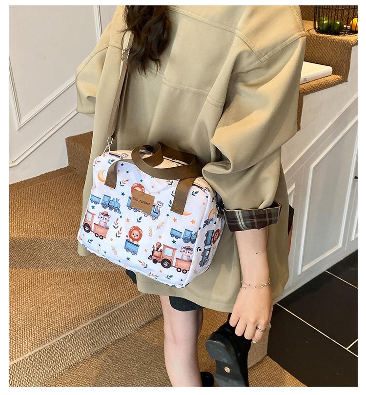 Single-shoulder slanted crossbody baby bag, cute cartoon design, large capacity, water-resistant, suitable for moms to carry out