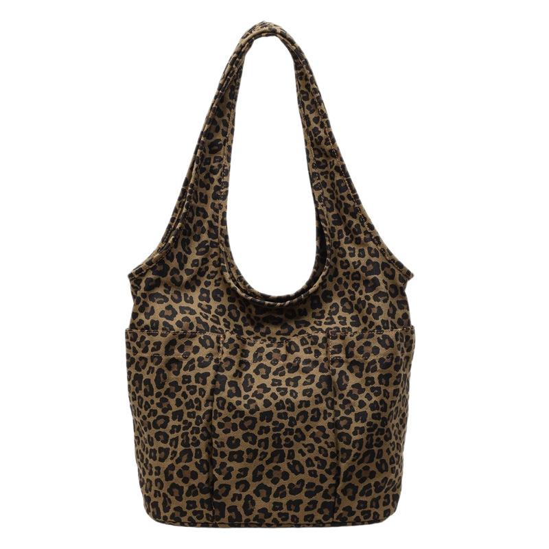 This season, Korean ins style leopard print canvas bag casual large capacity commuter women's shoulder underarm triangle tote bag