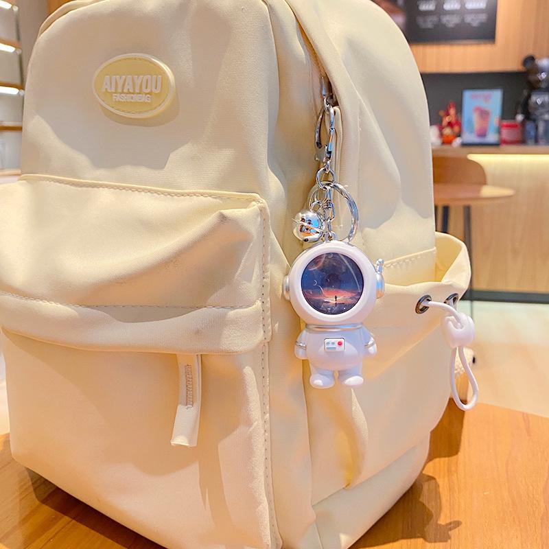 Creative Astronaut Starry Sky Keychain Pendant: Cartoon Doll Schoolbag Decoration, Perfect for Students or Couples.