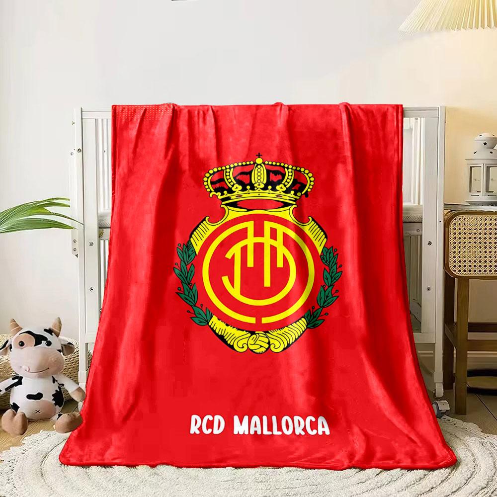A crowned emblem with yellow circular patterns on a red background. for all seasons blanket lunch break throw gift