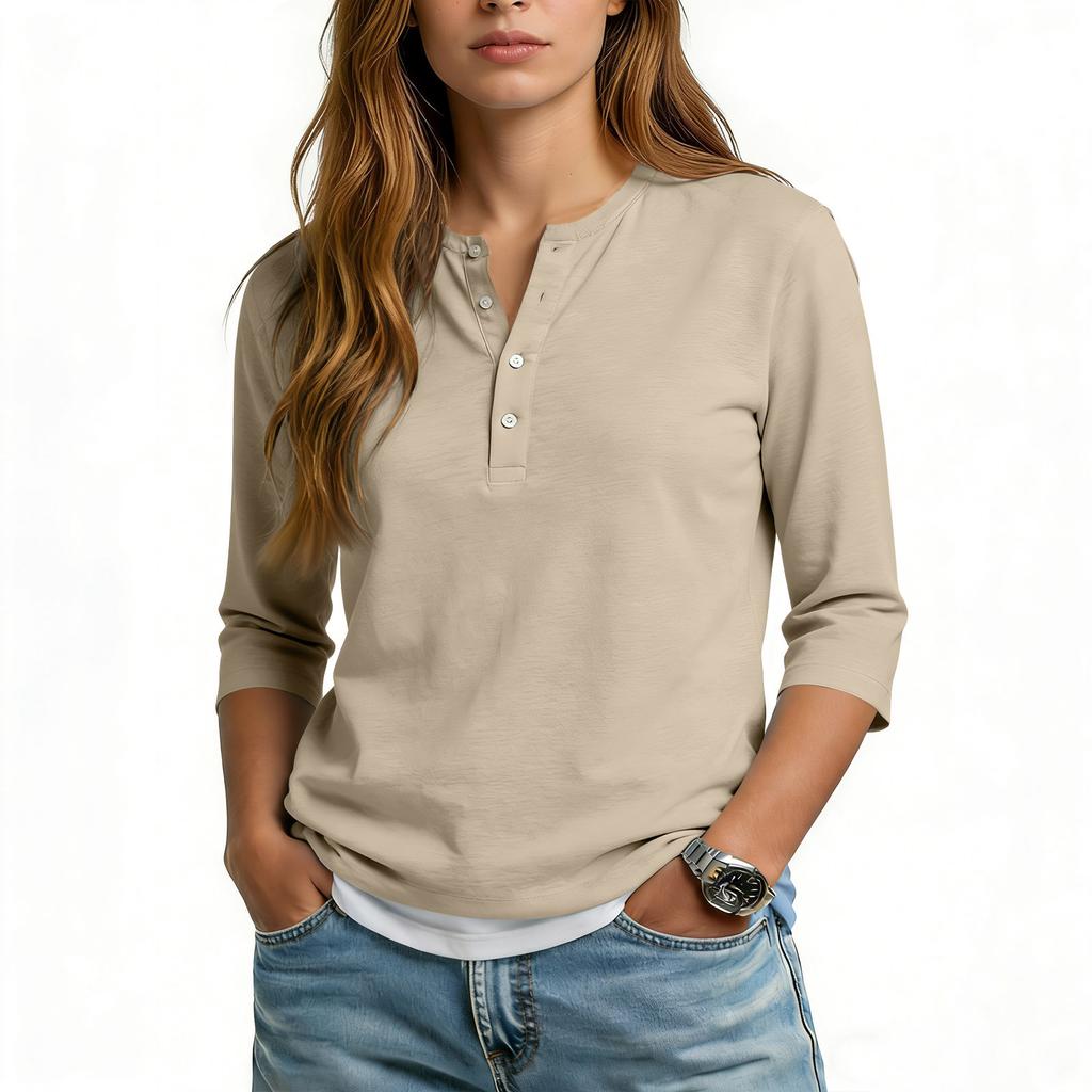 Camiseta informal de mujer con cuello en V, manga tres cuartos y botones decorativos.