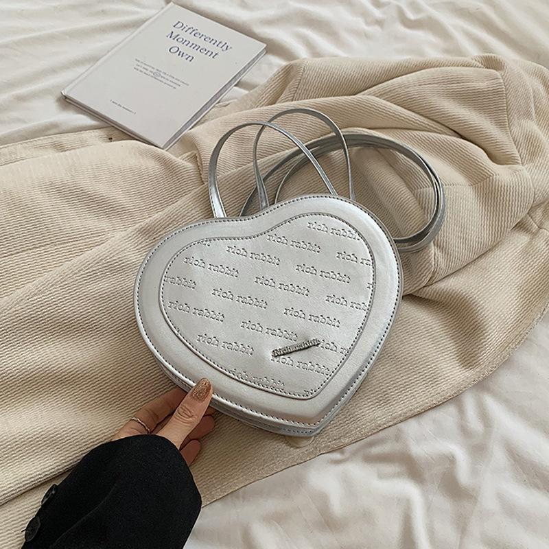 

Дизайнерська приміська жіноча сумка, модна невелика сумка у формі серця, проста ніша, літо 2024, нова модна сумка в іноземному стилі срібний