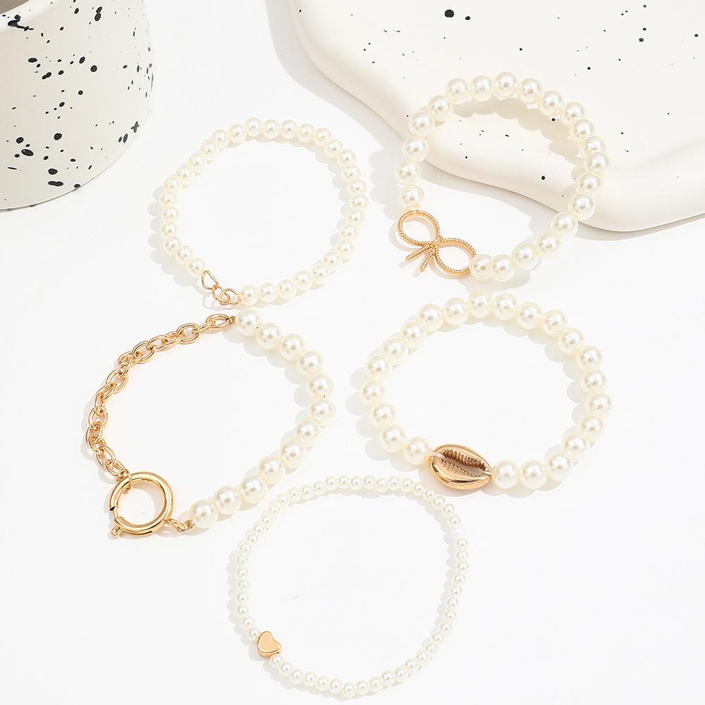 5-Piece Ocean-Inspired Faux Pearl Bracelet Set for Women with Bow, Heart, and Shell Accents