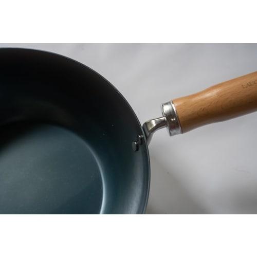The Little China 24 Iron Frying Pan, a small iron wok that develops with use. Made in Japan, induction compatible, lightweight, no seasoning required,