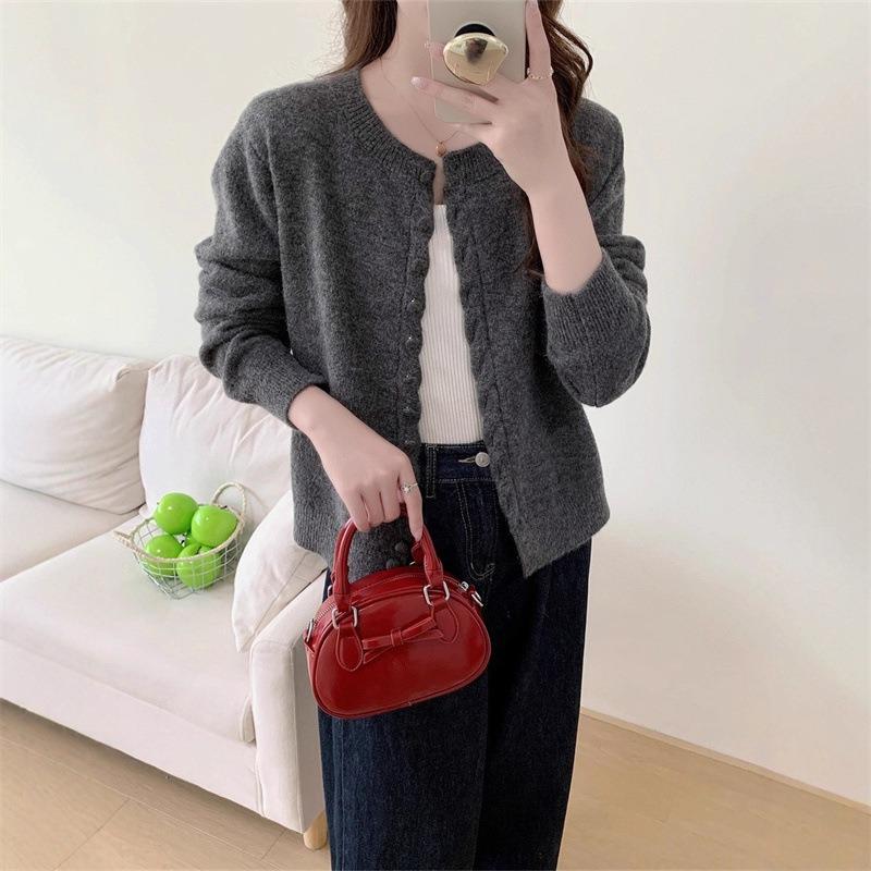 Autumn new solid color round neck single-breasted splicing long-sleeved knitted sweater women's fashion age-reducing top