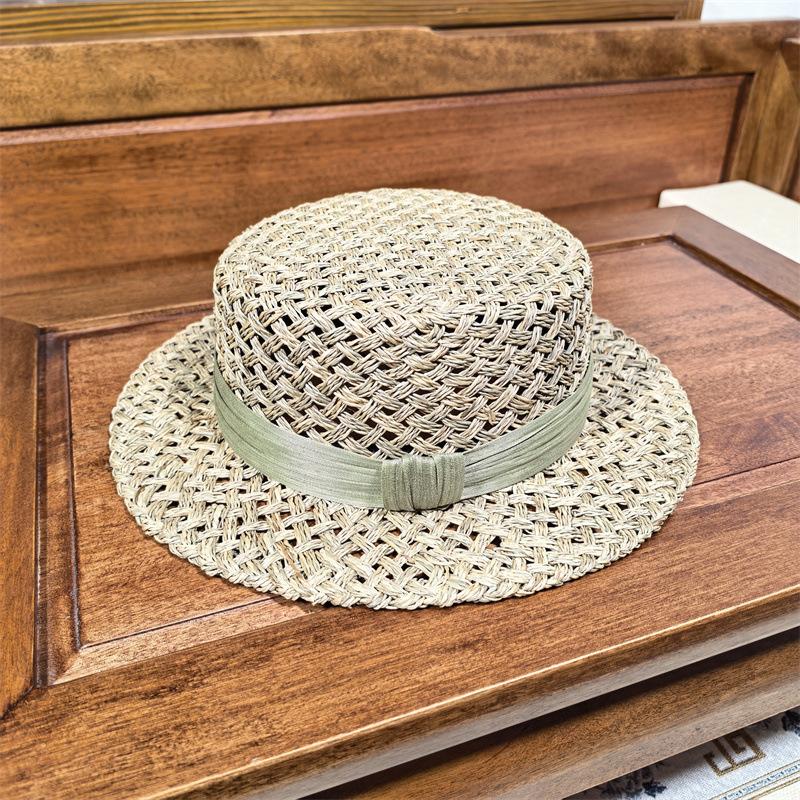 High sense handmade salty grass hollow woven straw hat women's French summer fashion beach hat British flat top hat tide