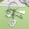Antique Silver Music Cassette & Saxophone Keychain with Creative Design