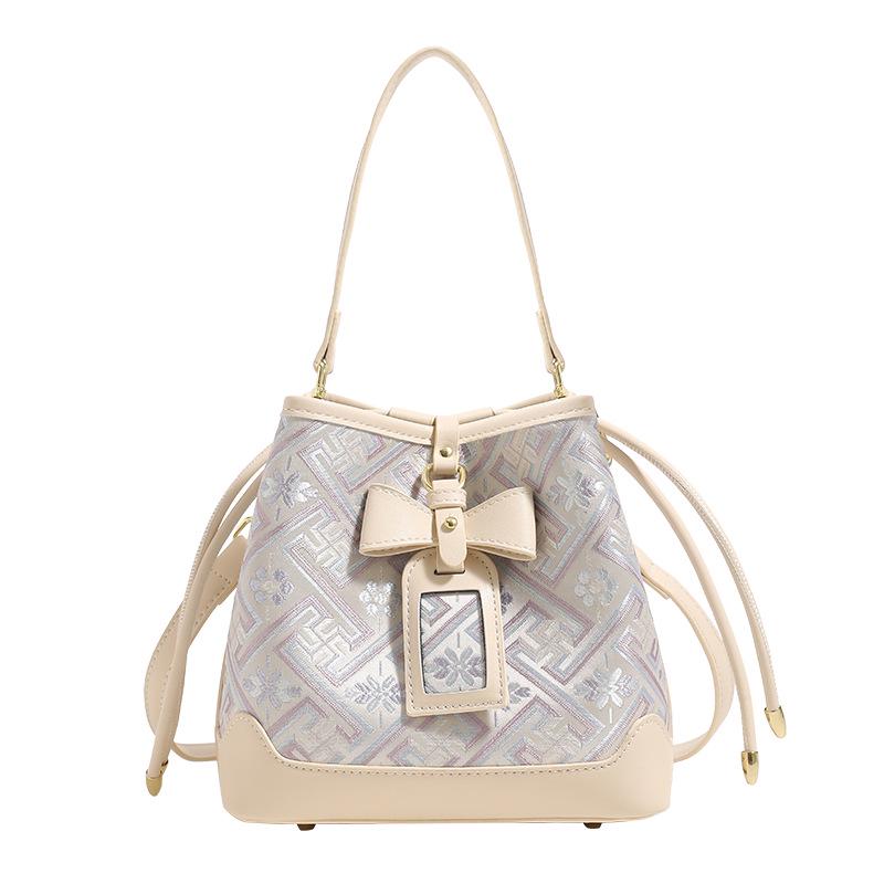 Guangxi Zhuang Brocade Heritage Women's Bow Drawstring Bag - 2026 New Chinese Style Crossbody Bucket Bag