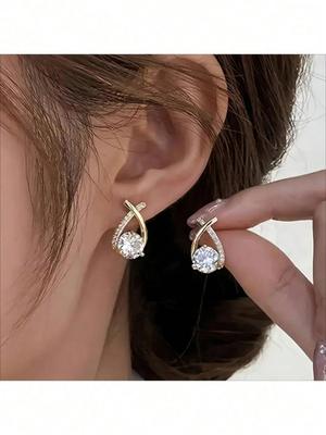 Gold Tone Teardrop Stud Earrings With Criss-Cross Cubic Zirconia Accents, Elegant Round-Cut Center Stone For Maximum Sparkle Comfortable Design
