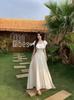 Biała Elegancka Długa Sukienka Plus Size z Jednym Rękawem i Falbankami