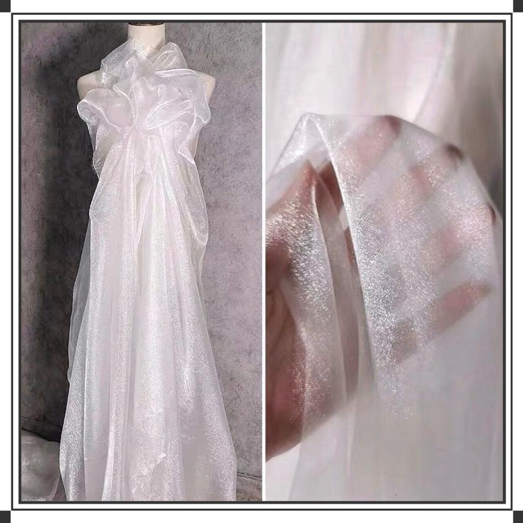 This white glittering hazy mesh fabric can be used for wedding dresses evening gowns and designer clothing fabrics