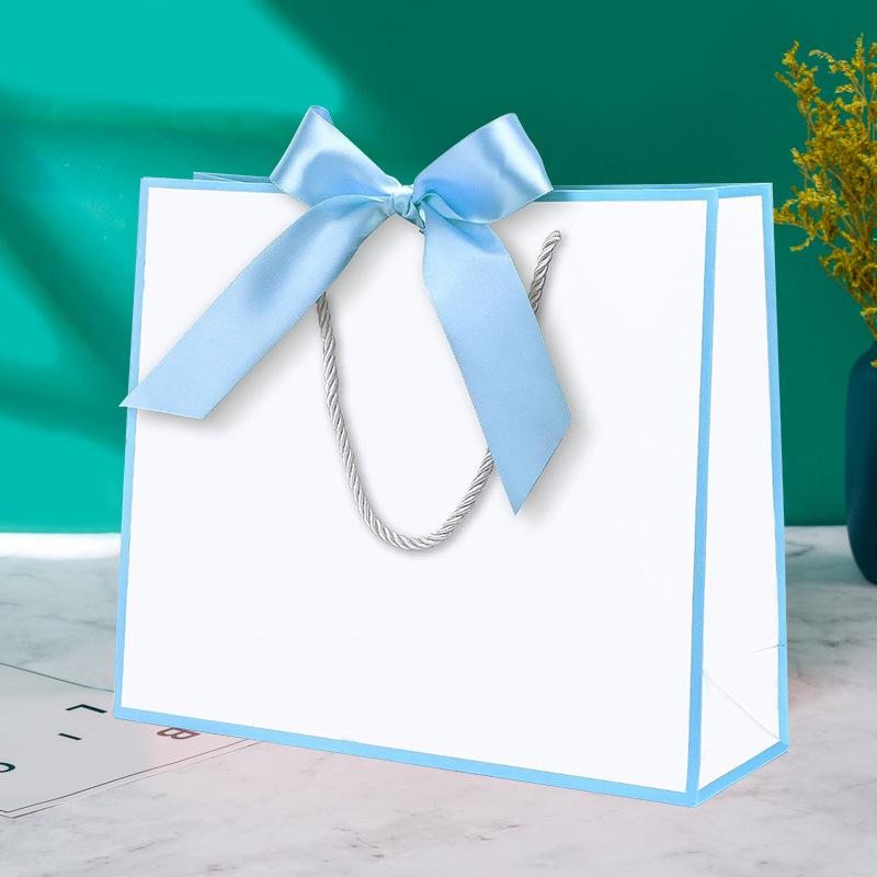 In-Stock White Cardboard Gift Bags with Bow Handle, Customizable Logo for Clothing Stores